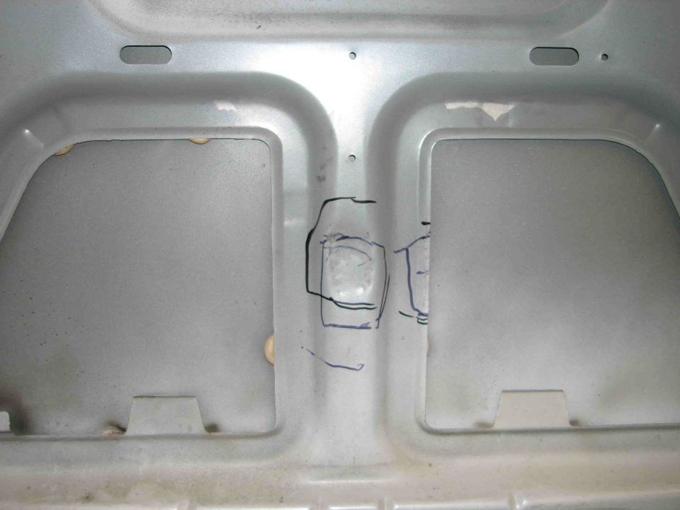 underside of a car hood with drawn markings
