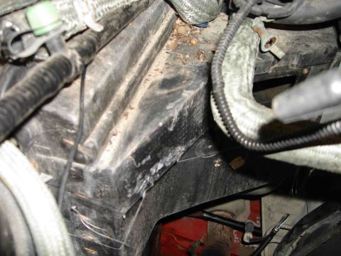 1997 Lincoln Town Car - Close-up view of a black plastic AC box with hoses and wiring, likely from an engine bay.