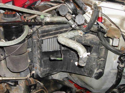 1997 Lincoln Town Car - The heater core assembly is visible within the black plastic housing, surrounded by various hoses and electrical components.