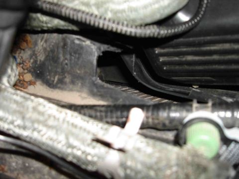 1997 Lincoln Town Car - A close-up view of the AC box area within a vehicle's engine bay, showing various hoses and wiring.