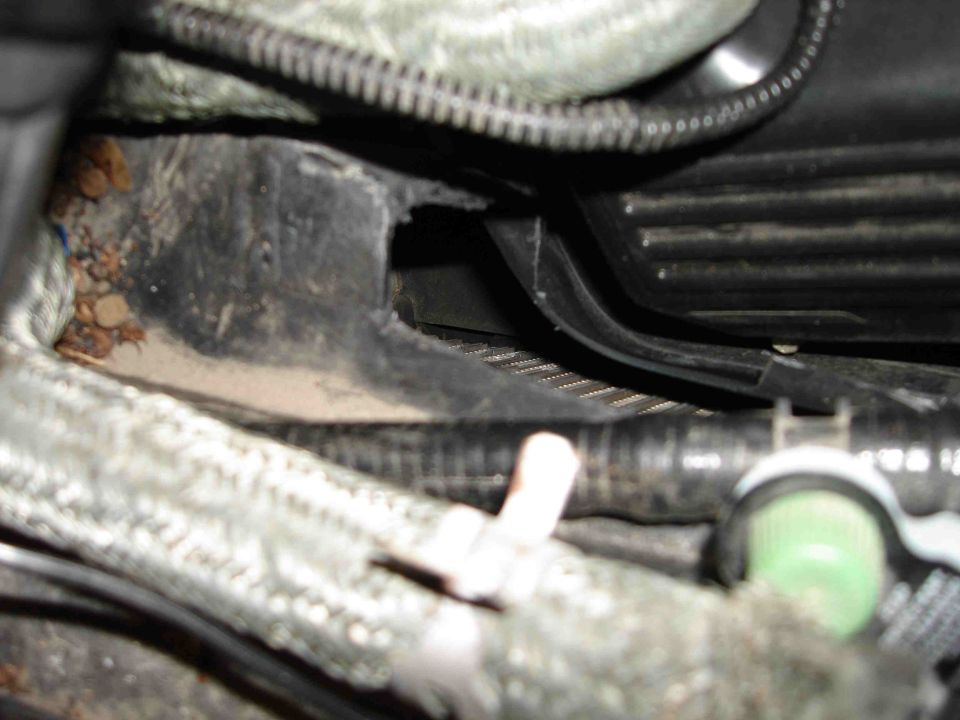 Close-up of a car's AC box with hoses and wiring