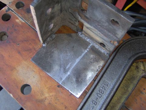 1993 Ford Bronco - A welded metal bracket is held by a clamp stamped with "1480-8" and "SUPERMOTORS.NET".