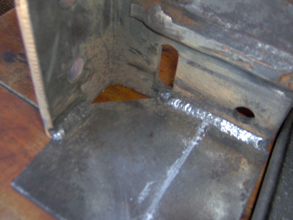 Close-up of a welded metal bracket with a cut-out
