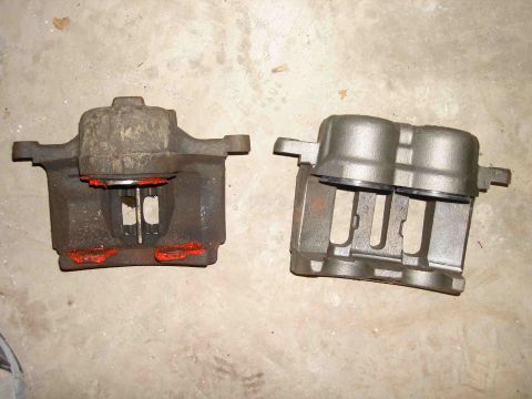 1997 Lincoln Town Car - A comparison of a used brake caliper next to a new one.
