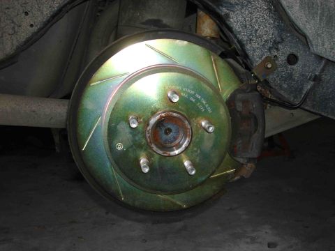 1997 Lincoln Town Car - A close-up view shows a vehicle's brake rotor and caliper, with visible text on the rotor.