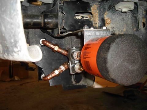 1997 Lincoln Town Car - This image shows an aftermarket oil filter and cooler lines, not a specific vehicle model year.