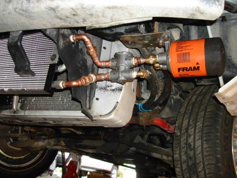 1997 Lincoln Town Car - Custom oil cooler and filter assembly installed on the undercarriage of a vehicle.