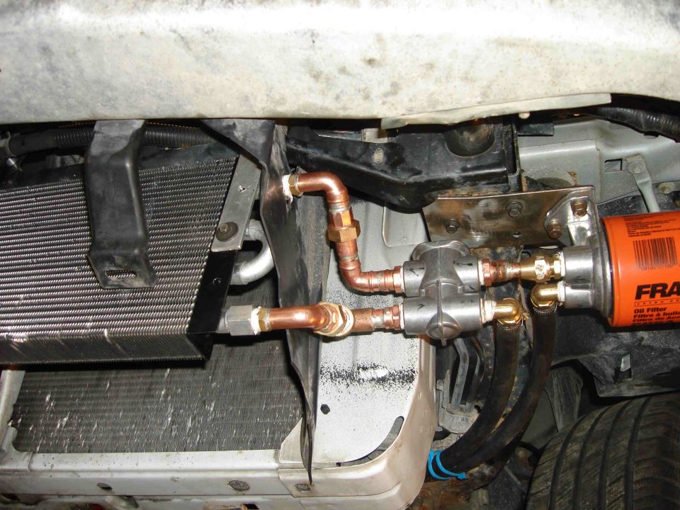 Copper oil lines linking finned oil cooler to remote FRAM filter adapter behind bumper