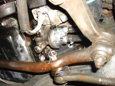 1997 Lincoln Town Car - This image shows a close-up view of an engine oil cooler assembly with attached hoses and mounting hardware.