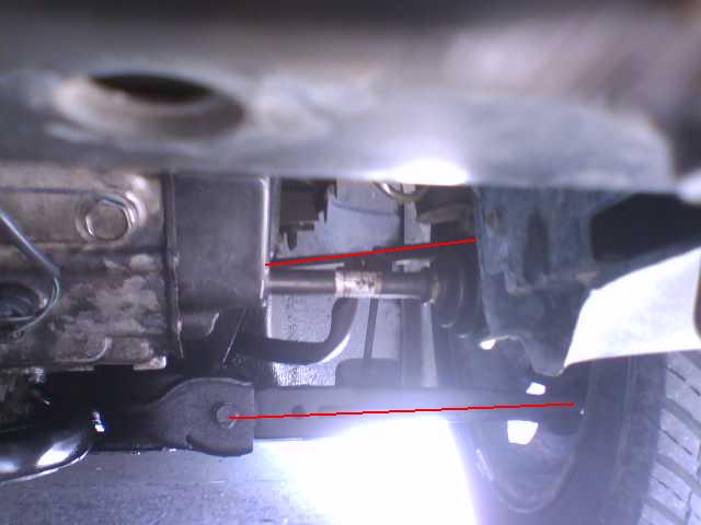 Underside view of a vehicle drivetrain component with red marker lines