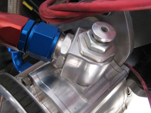 1979 Ford Bronco - A close-up shows a fuel line fitting with braided hose and anodized aluminum connectors.