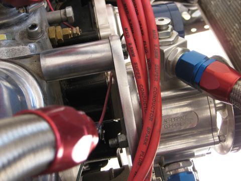 1979 Ford Bronco - Close-up view of engine components, including red spark plug wires and braided fuel lines.