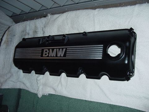1989 BMW 3 Series - BMW valve cover with silver stripes and logo, resting on a white towel.