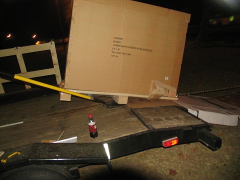 1988 Ford C-350 (Centurion Conversions) - Trailer loaded with a large box and shovel, parked outdoors at night.