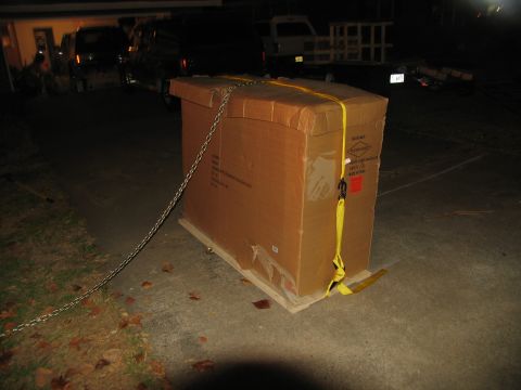 1988 Ford C-350 (Centurion Conversions) - A large box is secured on a pallet, with vehicles visible in the background.