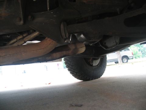 1988 Ford C-350 (Centurion Conversions) - The underside of a vehicle is shown, with a second vehicle partially visible in the background.