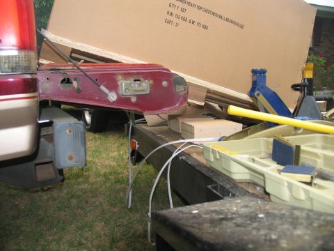 1988 Ford C-350 (Centurion Conversions) - Trailer loaded with boxes and a removed truck door, with tools nearby.