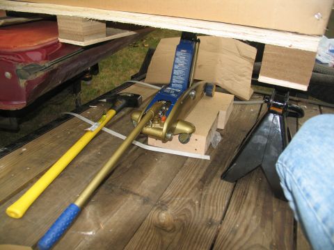 1988 Ford C-350 (Centurion Conversions) - Tools including a jack and jack stand are secured on a wooden surface.