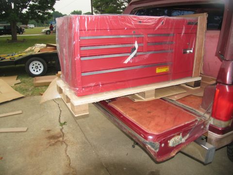 1988 Ford C-350 (Centurion Conversions) - Loading a large red toolbox into the bed of a pickup truck.