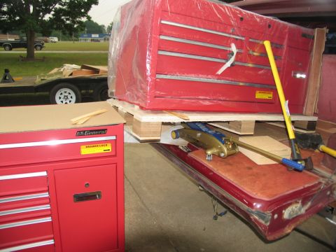 1988 Ford C-350 (Centurion Conversions) - Two red toolboxes are shown, one on a pallet with a car door and jack underneath.