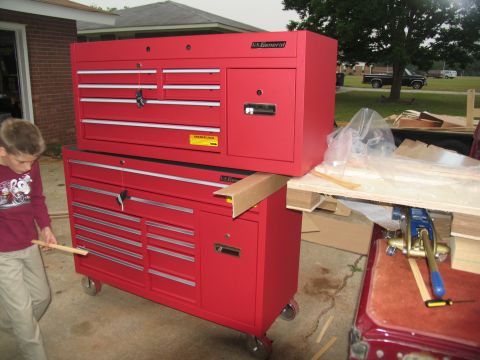 1988 Ford C-350 (Centurion Conversions) - Two red US General tool chests are stacked in a driveway, with a boy standing next to them.
