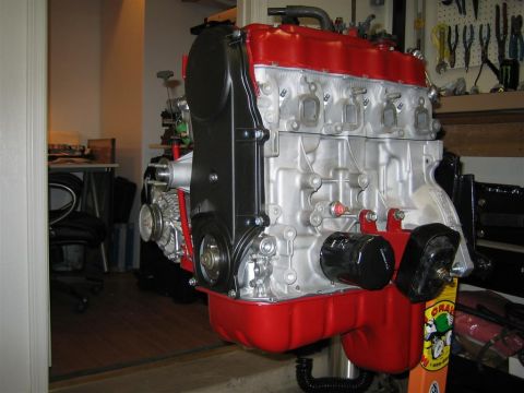 1987 Suzuki Samurai - A rebuilt engine is mounted on a stand in a workshop, ready for installation.