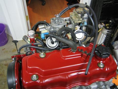 1987 Suzuki Samurai - Engine assembly with carburetor and fuel lines, possibly for a Suzuki Samurai.