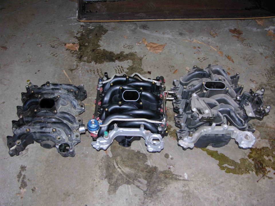 Three intake manifolds on concrete floor