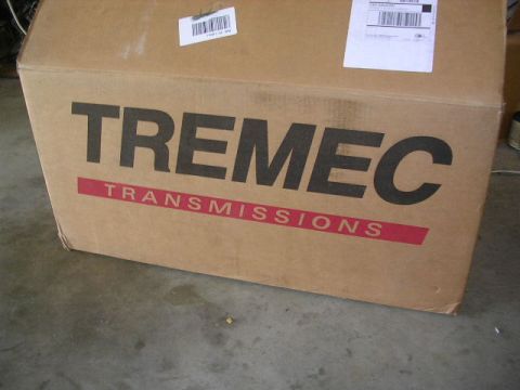 1975 Ford Ranchero - A large cardboard box labeled TREMEC TRANSMISSIONS sits on a concrete floor.