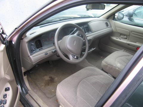 1991 Ford LTD Crown Victoria - Interior view of a 1990s Ford Crown Victoria, showing the dashboard, steering wheel, and front seats.