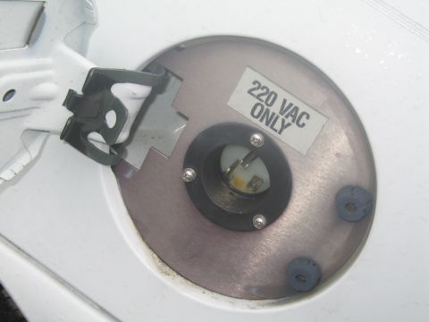 1991 Ford LTD Crown Victoria - This is a close-up of a vehicle's fuel filler door, modified to house a 220 VAC electrical outlet.