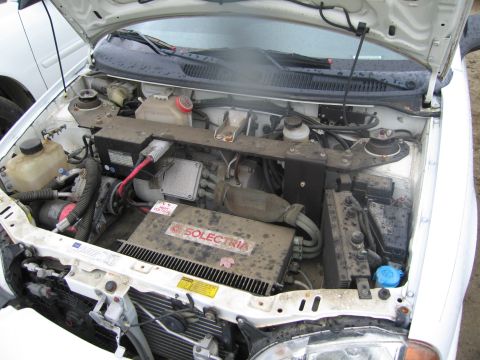1991 Ford LTD Crown Victoria - The engine bay of a vehicle, a prominent SOLECTRIA label on a large component.