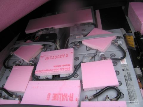 1991 Ford LTD Crown Victoria - Close-up view of multiple batteries secured with pink foam padding and black wiring.