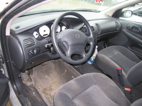 1991 Ford LTD Crown Victoria - The interior of a car shows the dashboard, steering wheel, and front seats, with dirty floor mats.