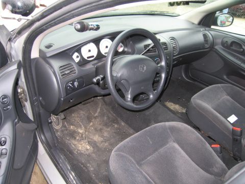 1991 Ford LTD Crown Victoria - The interior of a car, the driver's side dashboard and front seats, with the floor mats visibly soiled.