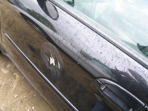 1991 Ford LTD Crown Victoria - The emblem on this car door is damaged and peeling off.