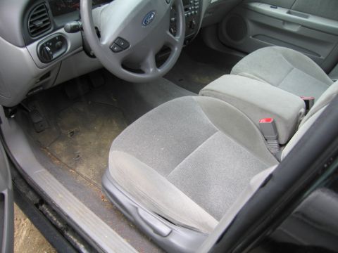1991 Ford LTD Crown Victoria - Interior of a car with cloth seats and a Ford steering wheel is visible.