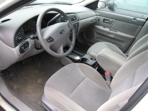 1991 Ford LTD Crown Victoria - Interior view of a car's cabin, showing the dashboard, steering wheel, and front seats.