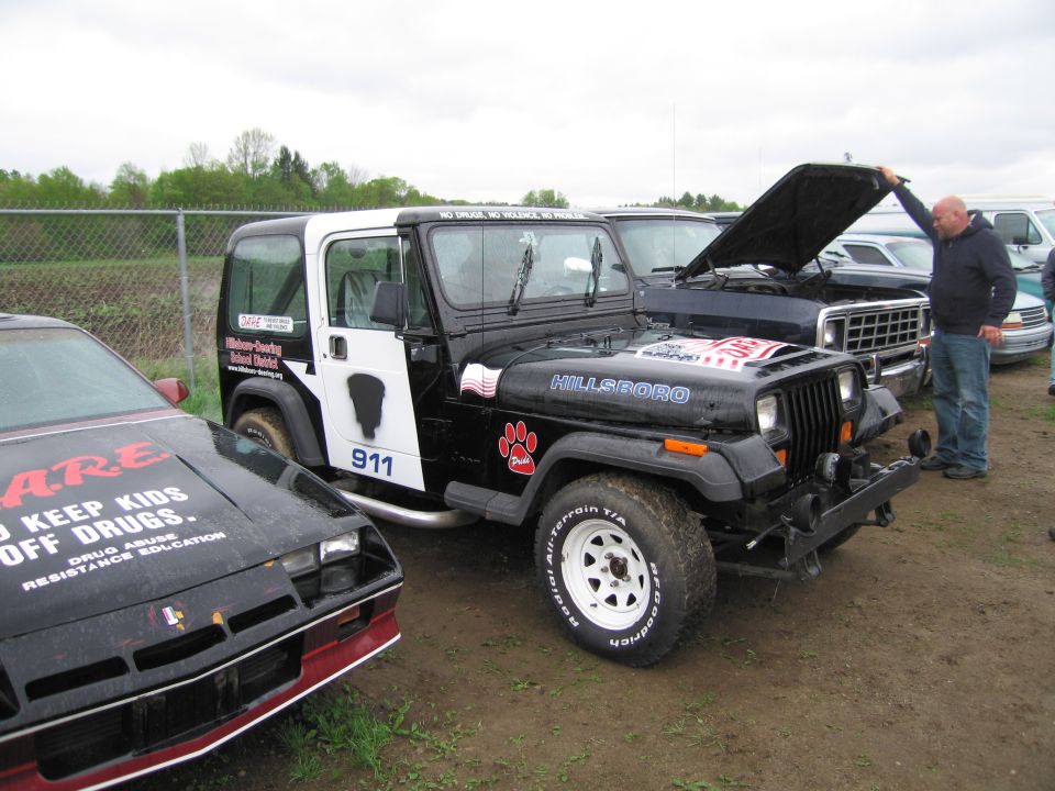 Black and white Jeep Wrangler with 'Hillsboro' text and paw print decals