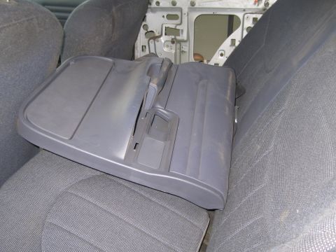 1991 Ford LTD Crown Victoria - Interior door panel removed from a vehicle, placed on the back seat.