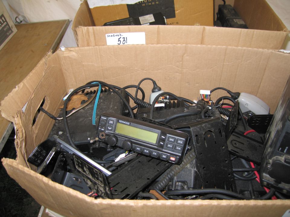 Cardboard box filled with various radio equipment, including a Kenwood radio
