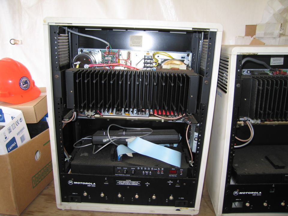 Two open electronic equipment racks with internal components and a Motorola label visible on the lower unit