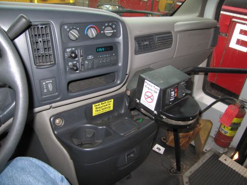 1991 Ford LTD Crown Victoria - Interior view of a bus dashboard showing controls, a radio, and a sign instructing to turn off the engine.