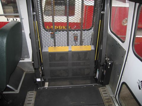 1991 Ford LTD Crown Victoria - The interior of a vehicle is visible, a lift gate and a glimpse of another vehicle's red exterior.