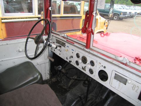 1991 Ford LTD Crown Victoria - The interior of a vehicle shows a dashboard with multiple gauges and a steering wheel, with a school bus visible outside.