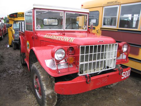 1991 Ford LTD Crown Victoria - A red fire truck with 'ALLENTOWN' written on the hood is parked next to a yellow school bus.