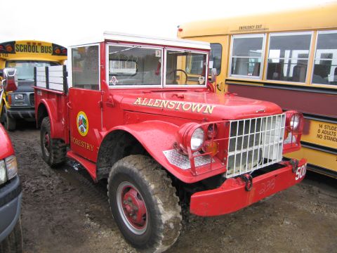 1991 Ford LTD Crown Victoria - A red truck with 'ALLENTOWN' and 'FORESTRY' text is parked next to a yellow school bus.