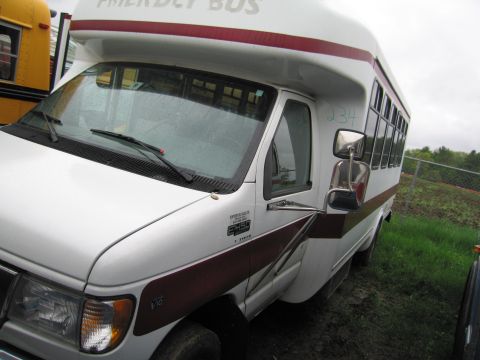 1991 Ford LTD Crown Victoria - A white bus with a maroon stripe and "FRIENDLY BUS" text is visible next to a yellow school bus.