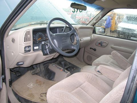 1991 Ford LTD Crown Victoria - The interior of a Chevrolet pickup truck is shown, with a tag reading '370' attached to the windshield.