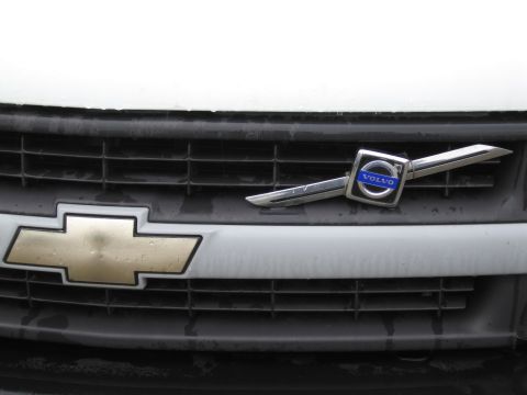 1991 Ford LTD Crown Victoria - A Volvo emblem is affixed to the grille of a Chevrolet vehicle.